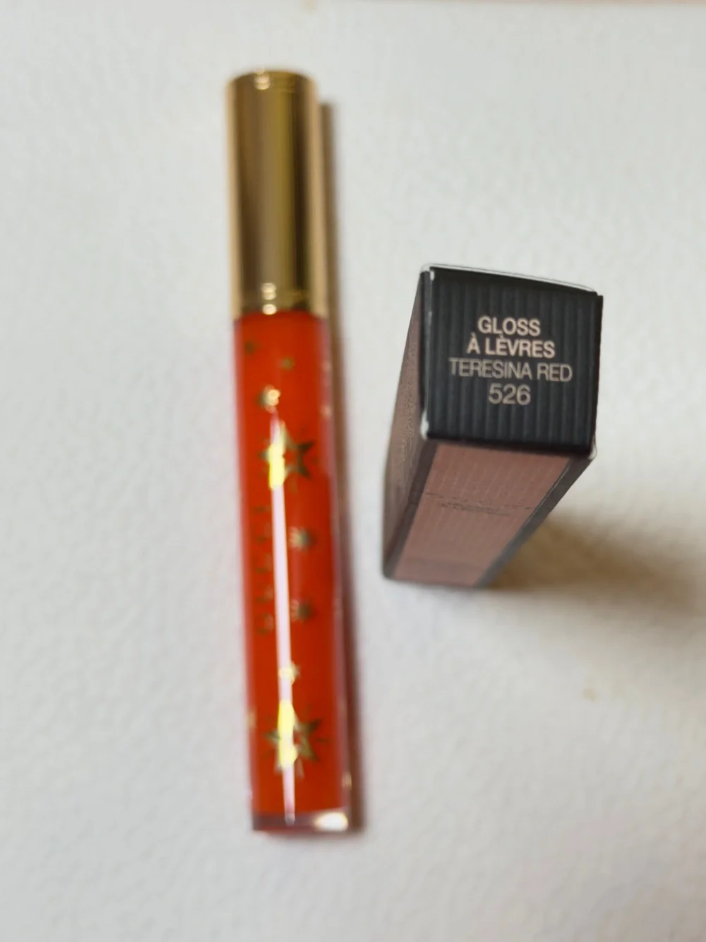 Gucci Orange-Red Lip Gloss with Gold Star Accents